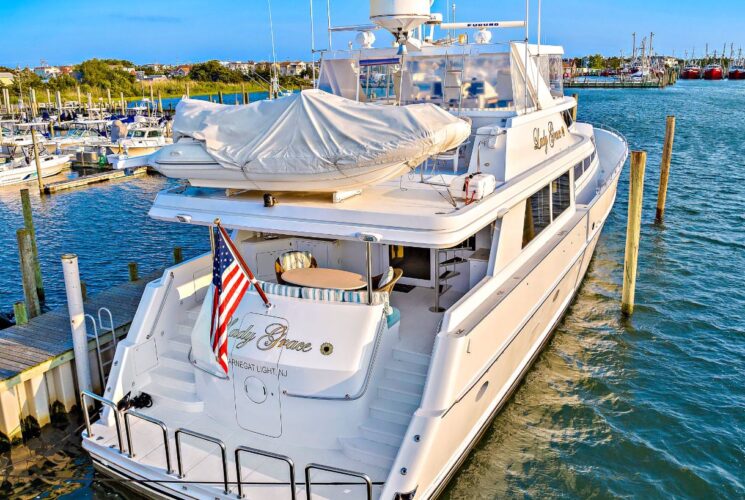 Swim step area of white yacht named Lady Grace docked in a marina